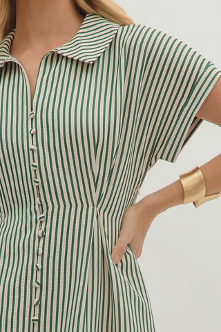 Striped short sleeve midi dress featuring shirt collar, pleated waist seam. Side pockets. Button closure at front. Zipper at side. Lined. Woven. Non-sheer. Lightweight.