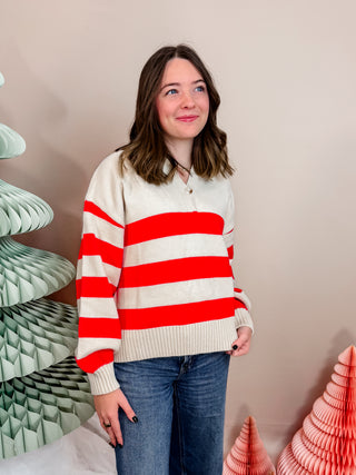 Red and cream striped knit sweater with front button closure, collar, and cuffed sleeves. Vibrant and Cozy. 