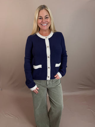 Two-Tone Button Front Cardigan Sweater with round crew neckline, two front patch pockets, contrast trim, and metallic buttons.