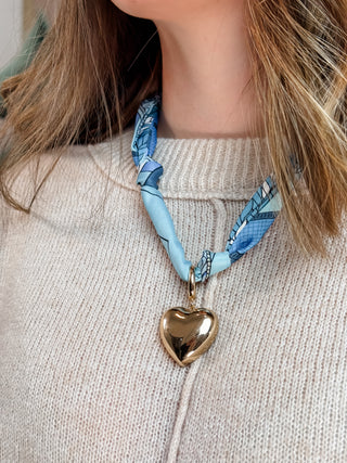 blue scarf necklace with large gold puffy heart charm