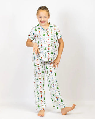 Child wearing Christmas-themed Nutcracker Waltz pajamas on a white background