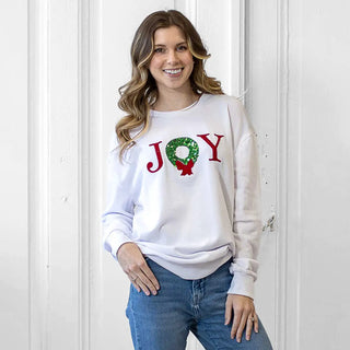White sweatshirt with green and red sequin joy design. 