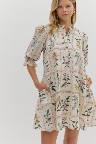 Floral panel ¾ ruffle finish puff sleeve pleated round neck button closure at front mini dress featuring adjustable back waist. Side pockets. Lined. Woven. Non-sheer. Lightweight.