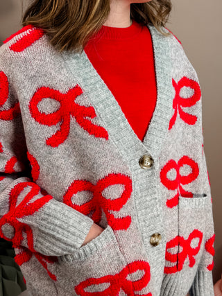 V NECKLINE LONG SLEEVES DROP SHOULDER EXTENDED SHOULDER RELAXED FIT OVERSIZED BOW JACQUARD PATTERN KNIT CARDIGAN SWEATER WOOL BLEND.