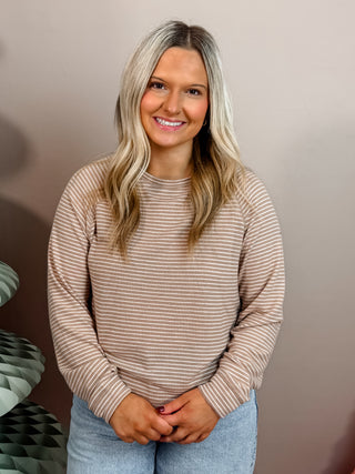 Beige and white striped soft knit top with long sleeves, crew neckline, and relaxed fit