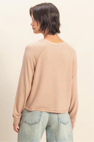 Beige and white striped soft knit top with long sleeves, crew neckline, and relaxed fit