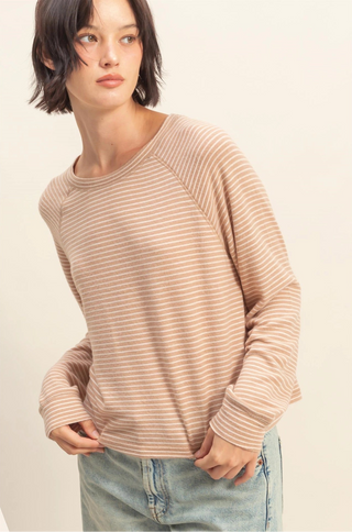 Beige and white striped soft knit top with long sleeves, crew neckline, and relaxed fit