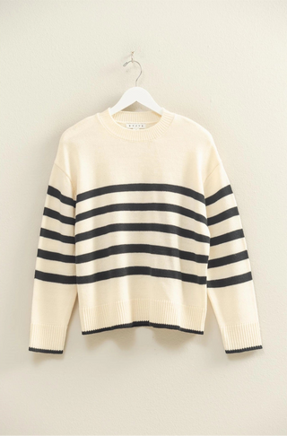 White sweater with black stripes, crew neckline, and easygoing fit. 