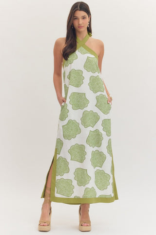 Shell print halter neck maxi dress featuring cross halter neckline. Tie closure at back neck. Side pockets. Side slits. Lined. Woven. Non-sheer. Lightweight.