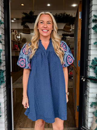 Mini navy dress with seersucker checkered material and embroidered puff sleeves
