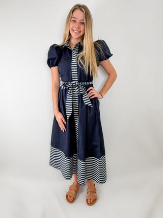 Navy maxi dress with stripe contrast details, tie waist, and puff sleeves