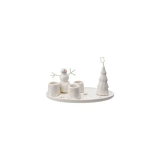 Decorative taper holder with a snowman and tree on a white background