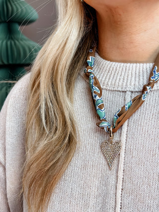 brown and blue scarf necklace with large gold pave heart charm