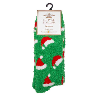 Green fuzzy socks with Santa hats on a hanger against a white background.