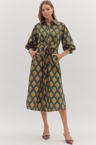 Botanical print half sleeve midi dress featuring self-tie belt at waist and button closure at front. Shirt collar. Buttoned cuffs. Lined. Woven. Non-sheer. Medium weight.