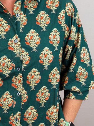 Botanical print half sleeve midi dress featuring self-tie belt at waist and button closure at front. Shirt collar. Buttoned cuffs. Lined. Woven. Non-sheer. Medium weight.