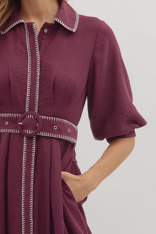 Solid short puff sleeve midi dress featuring contrast embroidered blanket stitch trim and removable belt at waist. Button closure at front. Side pockets. Lined. Woven. Non-sheer. Lightweight.